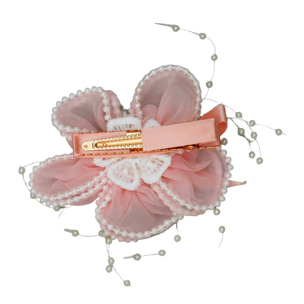 Side view of Yellow Bee's peach daisy hair clip, showcasing the delicate faux pearl work.