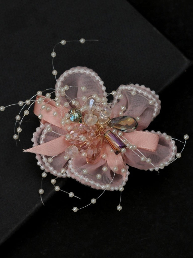  Intricate details of Yellow Bee's embellished daisy hair clip in peach, perfect for adding a touch of elegance.