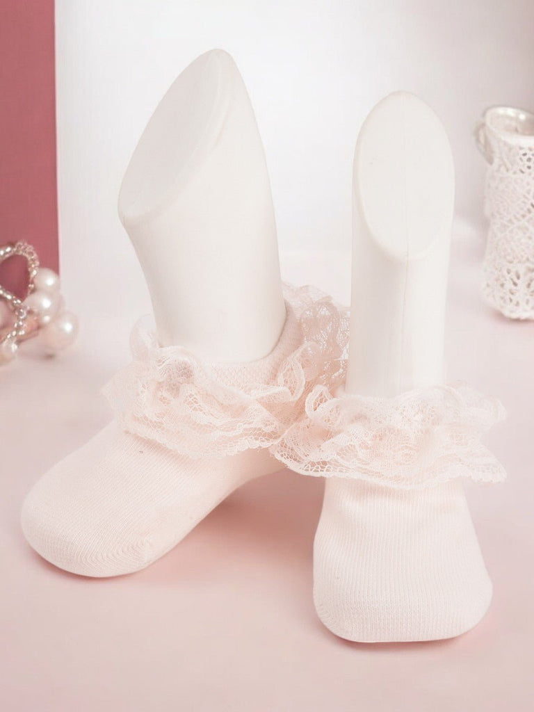 Elegant Pink Lace Frill Socks on Mannequin Feet Against White Background