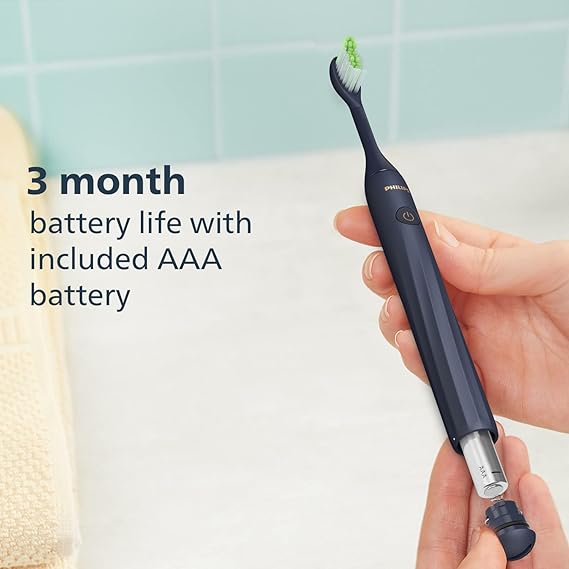 Close-up view of the navy blue Philips One by Sonicare toothbrush, highlighting the micro vibrating bristles for effective cleaning.