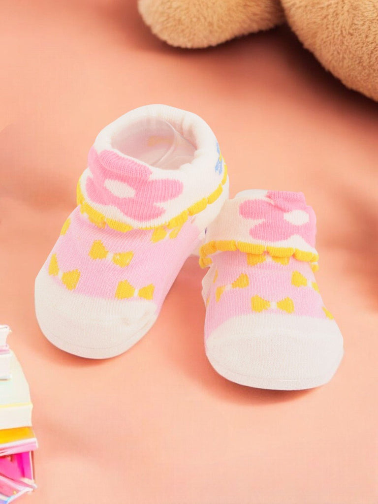 Pink Baby Socks with Yellow Bows and Flower Cuffs Creative View.