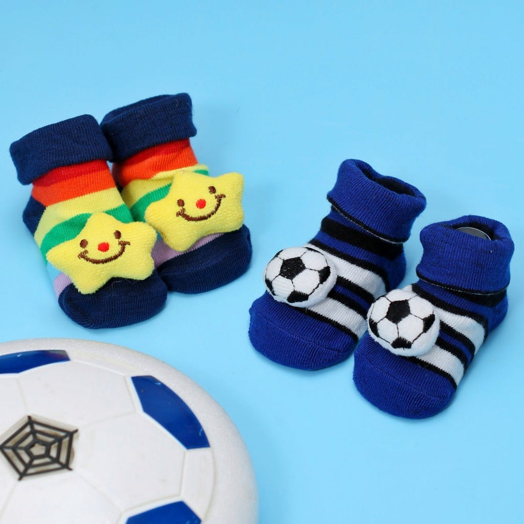 Colorful baby boy socks with star and football designs on blue background