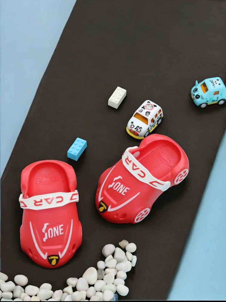 Pair of Red Car-Themed Kids' Clogs on a Playful Racetrack Setting