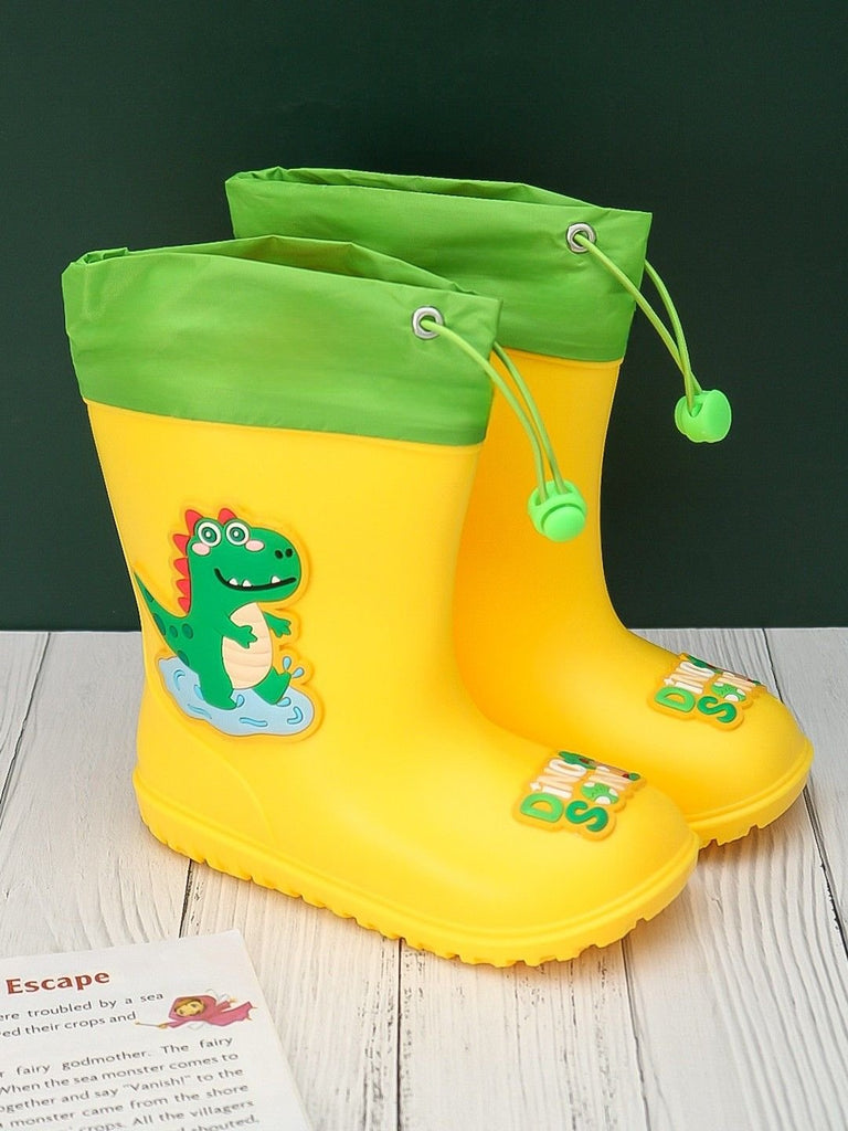 Safari Splash Yellow Dino Themed Rain Boots displayed creatively with props