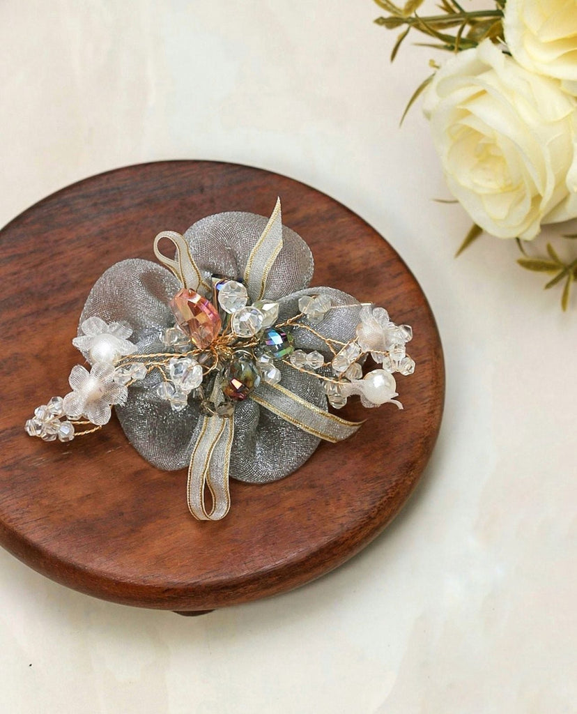 Display of Yellow Bee's charming grey daisy hair clip, perfect for adding a touch of class to any hairstyle.