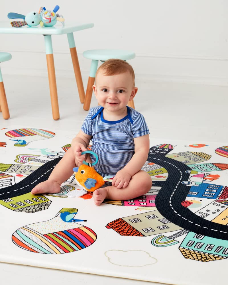  Image showing a child playing on the Skip Hop Doubleplay Reversible Playmat, highlighting the spacious and comfortable play area.