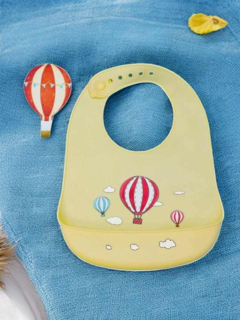 Creative display of Sky High Adventures Silicone Baby Bib for Boys with playful sky and balloon graphics.