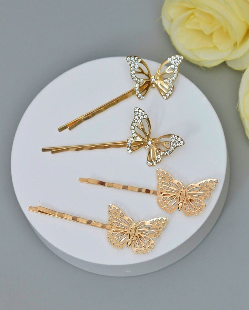 Arrangement of Yellow Bee's golden butterfly hair clips with sparkling stones on a display.