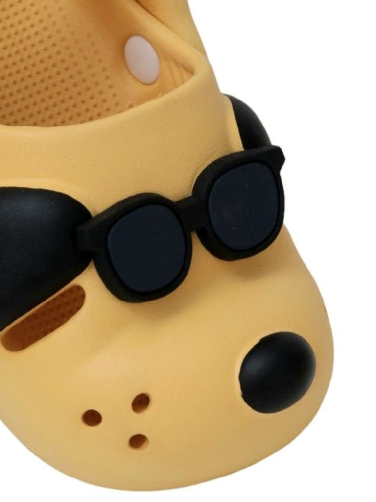 Close-up view highlighting the detailed sunglasses on the puppy design of the Sunny Shades Boy's Clogs.