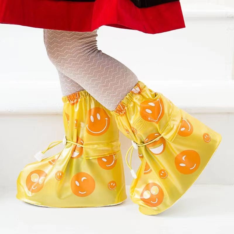 Creative setup showing Yellow Bee Sunny Yellow Smiley Waterproof Rain Shoe Covers for Boys worn with a stylish outfit.