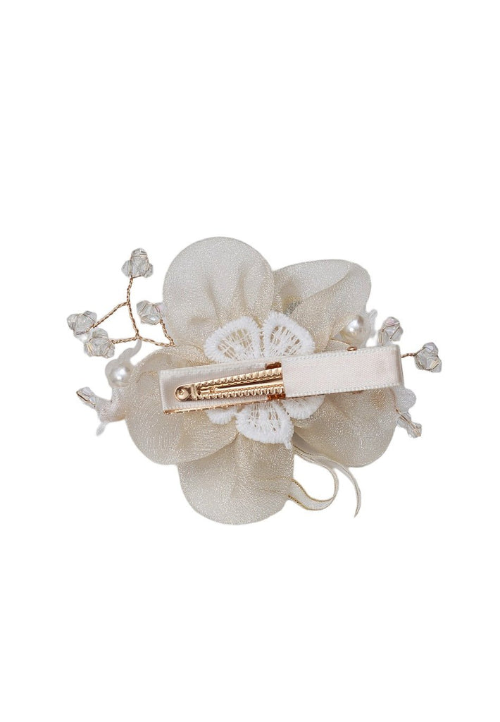 Back view of Yellow Bee's off white embellished daisy hair clip, featuring a secure alligator clip.
