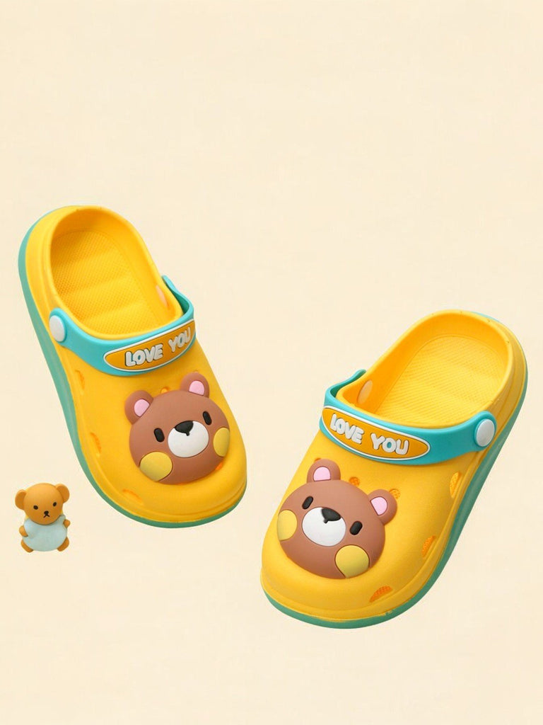 Cheerful yellow clogs with bear design and 'LOVE YOU' strap for kids on neutral background.