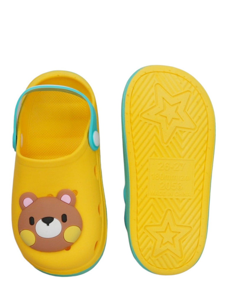 Underneath view of kids' yellow clog showcasing the star-patterned non-slip sole.