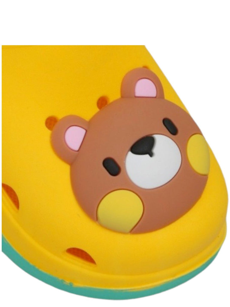 Close-up of the cute bear face on the toe of a kid's yellow clog.