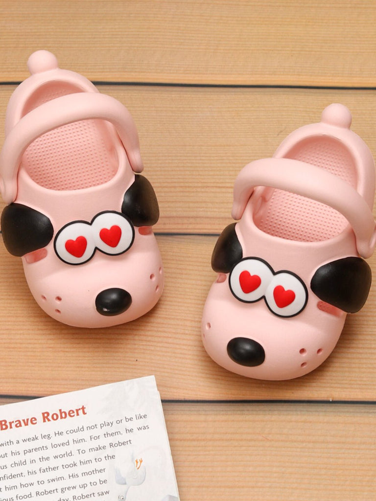 Yellow Bee's Sweetheart Soft Pink Puppy Clogs displayed with a children's book, emphasizing the playful and story-like design.