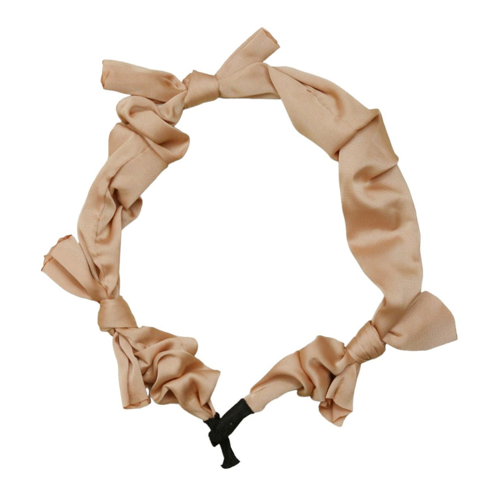 Close-up of Yellow Bee's Beige Bow Hairband, perfect for secure and stylish hair management