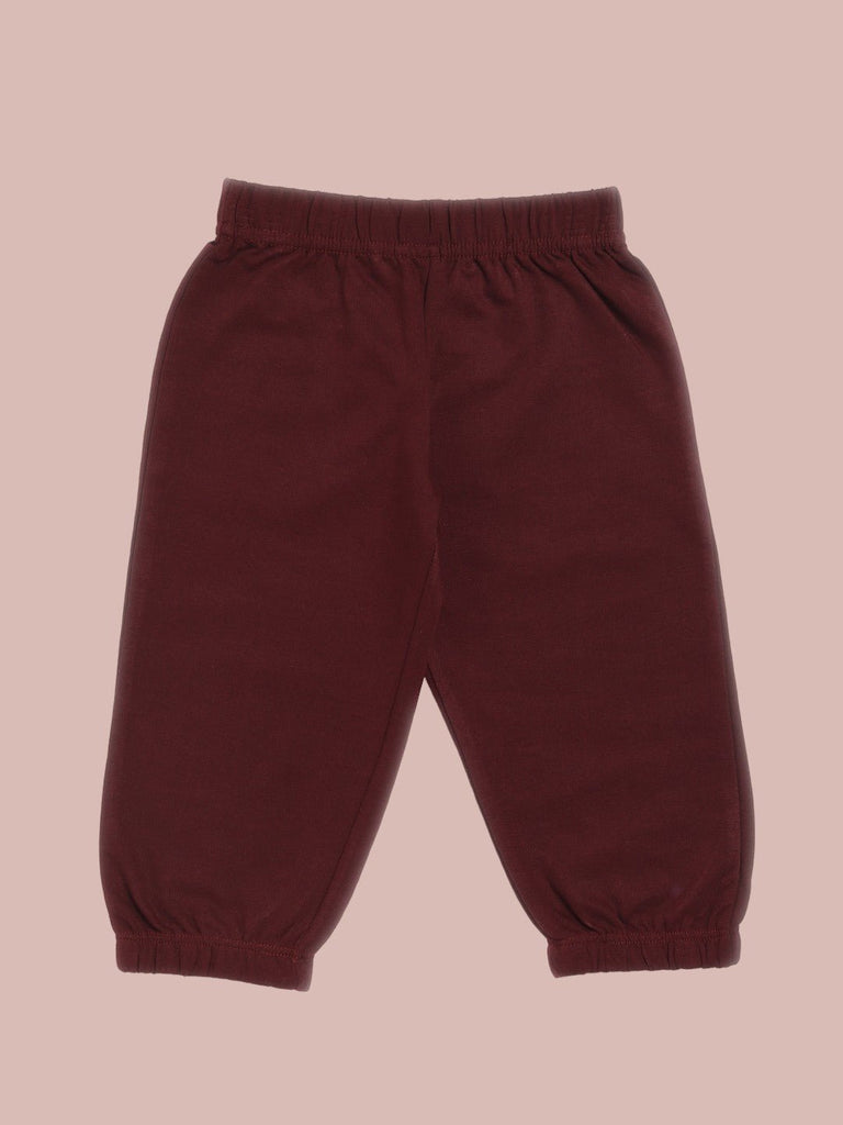 Back view of maroon tracksuit pants with an elastic waistband.