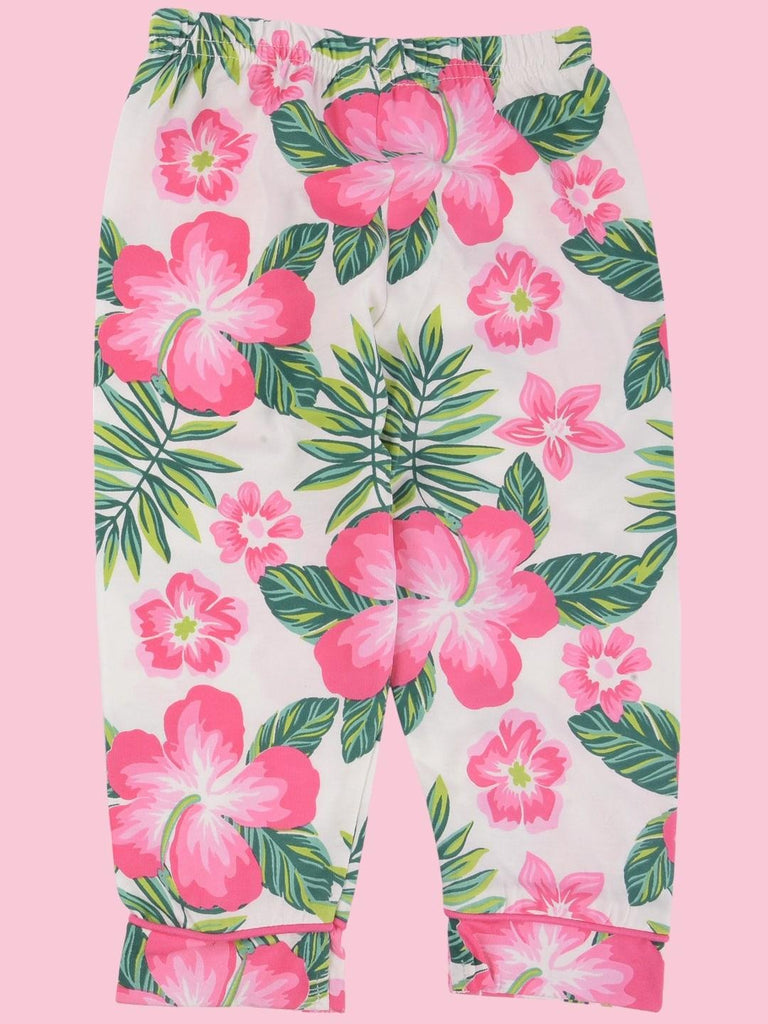 Close-up of the floral pajama pants in the ToffyHouse Girls' Tropical Floral Set with pink flowers and green leaves
