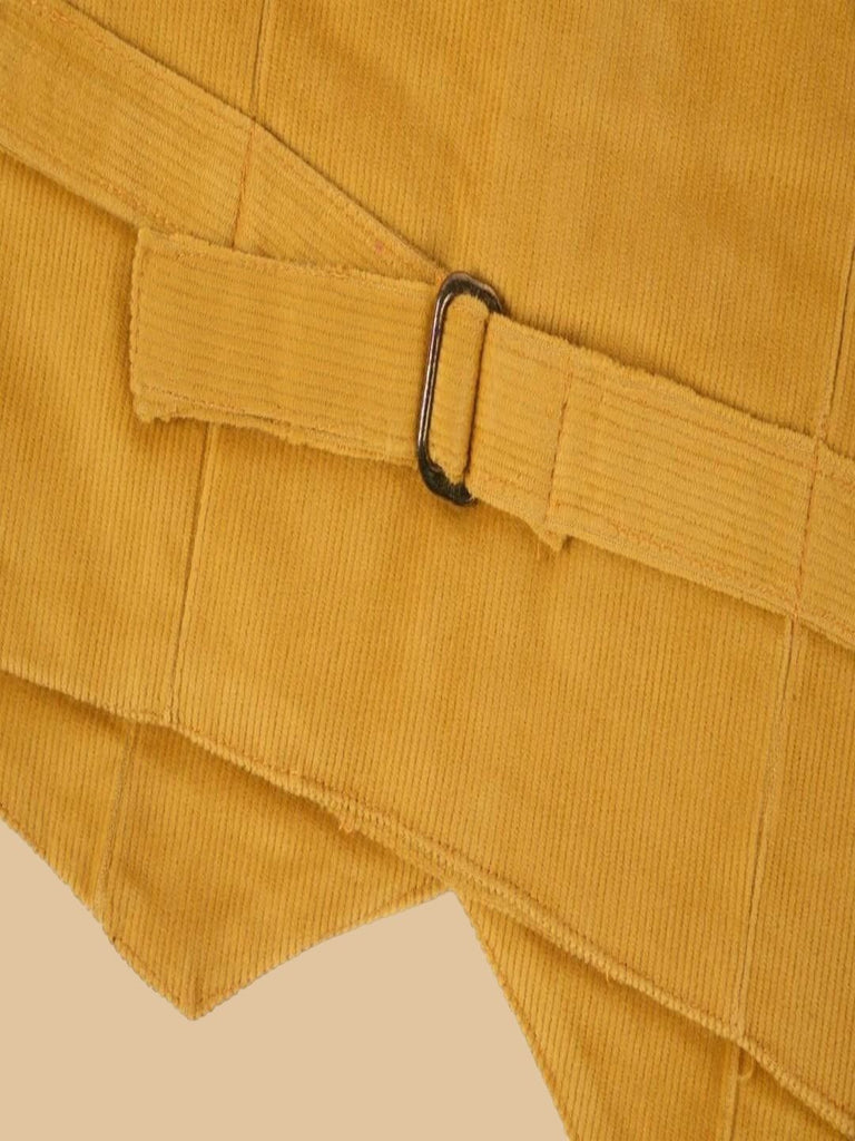 Back bottom view of a golden corduroy vest, highlighting the adjustable strap with a metal buckle.