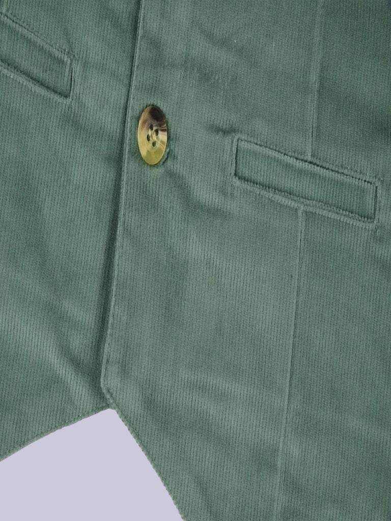 A detailed view of the bottom section of the vibrant green corduroy vest with front pockets.