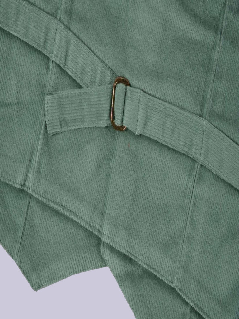 A detailed view of the back bottom section of the vibrant green corduroy vest, highlighting the fabric and stitching.