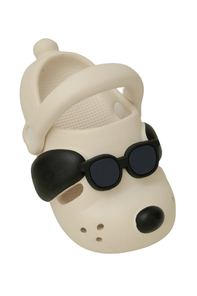 Angle view showing the chic off-white color and playful sunglasses puppy design of the Trendy Pup Boy's Clogs.