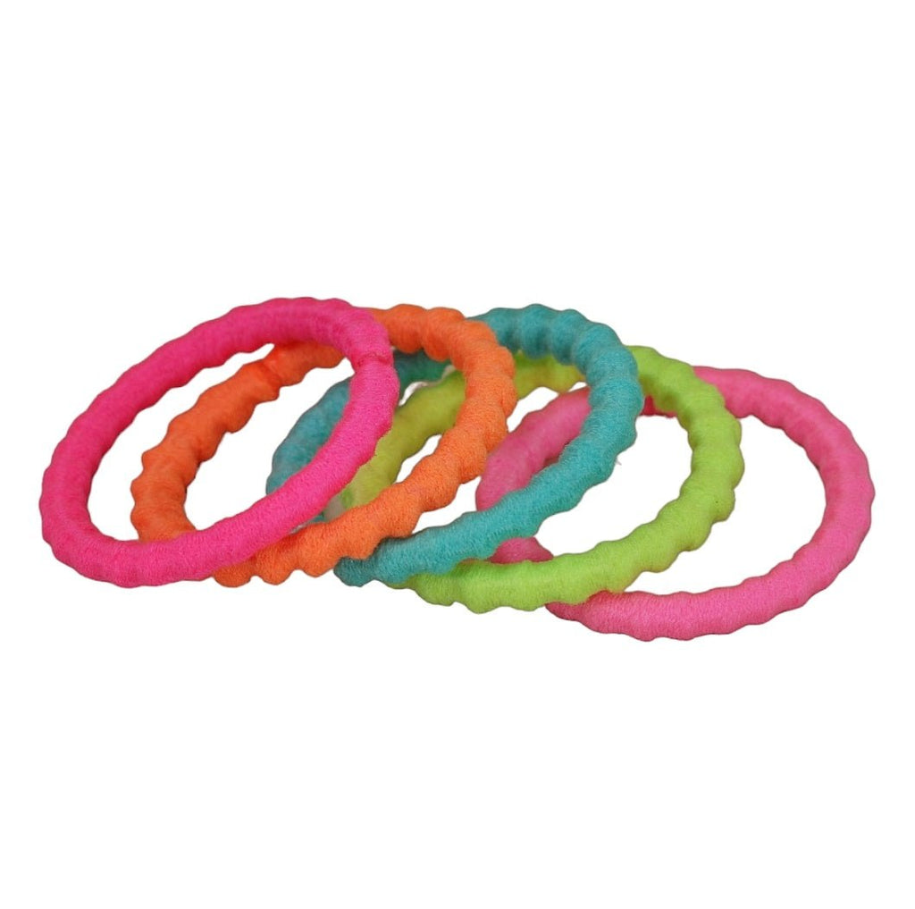 Stacks of Yellow Bee's soft and stretchable colorful hair ties in multiple hues