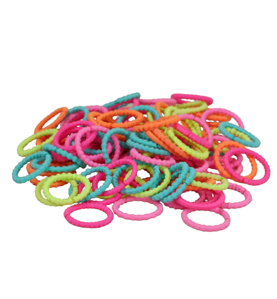 An array of Yellow Bee's colorful hair ties spread out showcasing the variety of vibrant colors.
