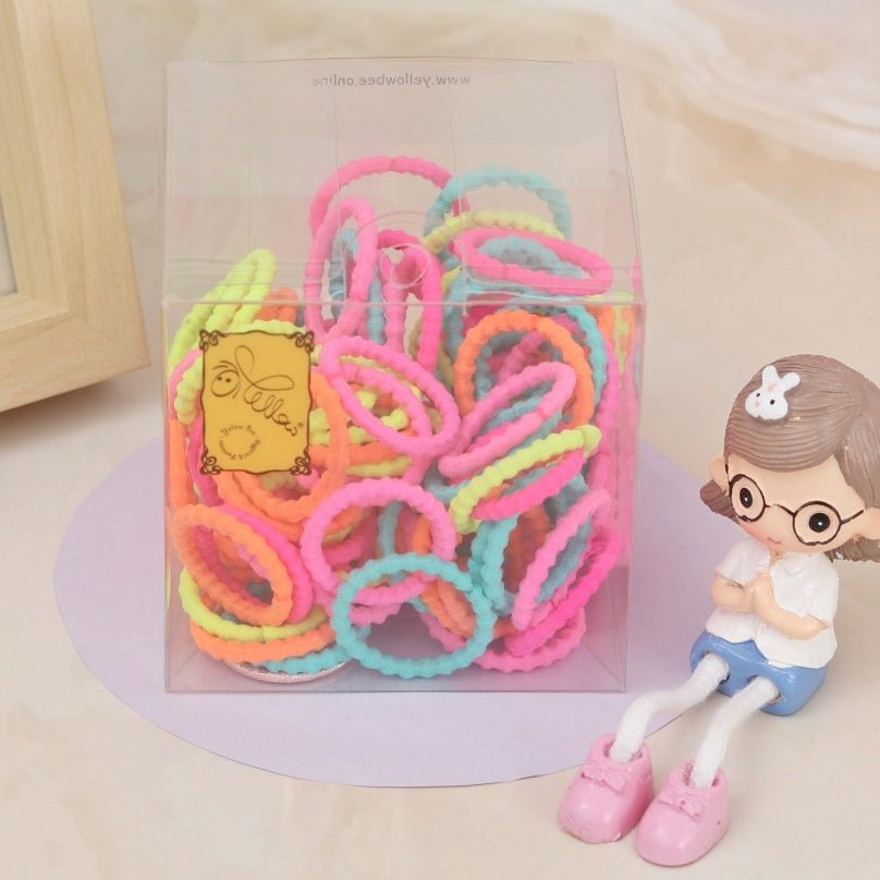  Pack of 100 Yellow Bee colorful elastic hair ties in a transparent box with a playful figurine.