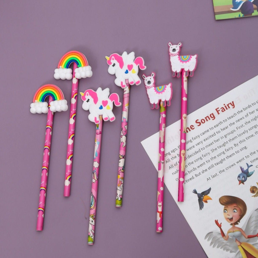 Overhead view of Yellow Bee's pencil set with rainbow, unicorn, and llama toppers, perfect for inspiring young writers.