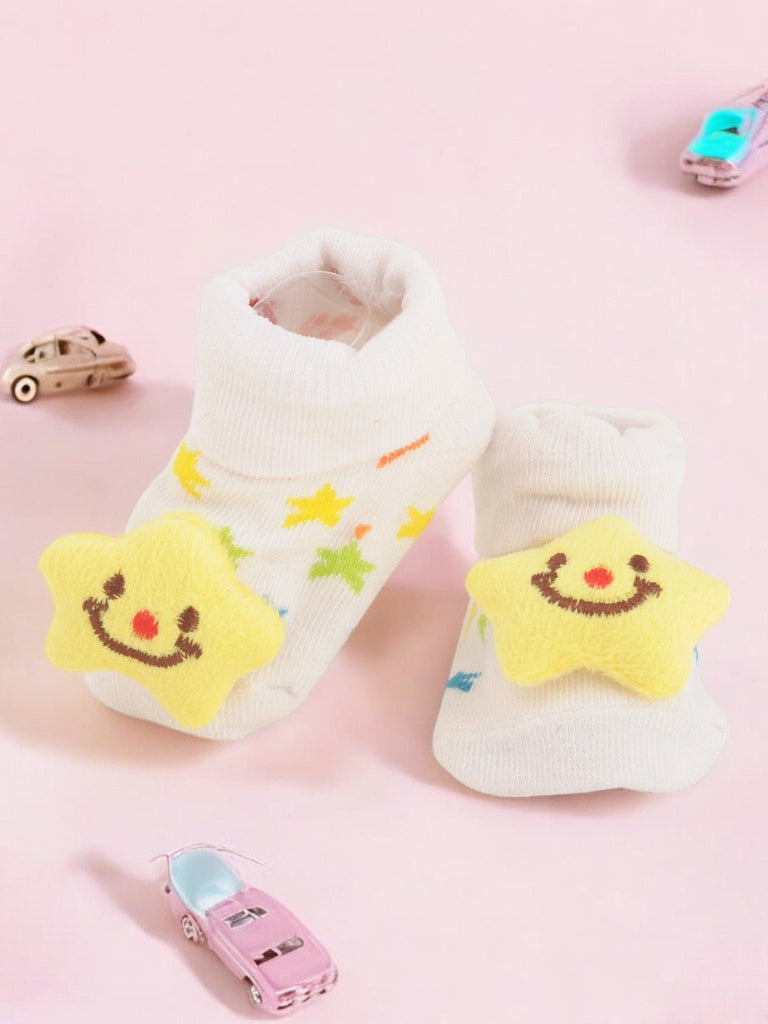 Creative view of White Baby Socks with Smiling Star and Colorful Starry Design