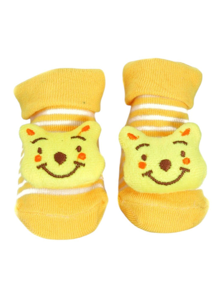 Top view of yellow baby booties showcasing a cute 3D bear face design, perfect for baby boys and girls.