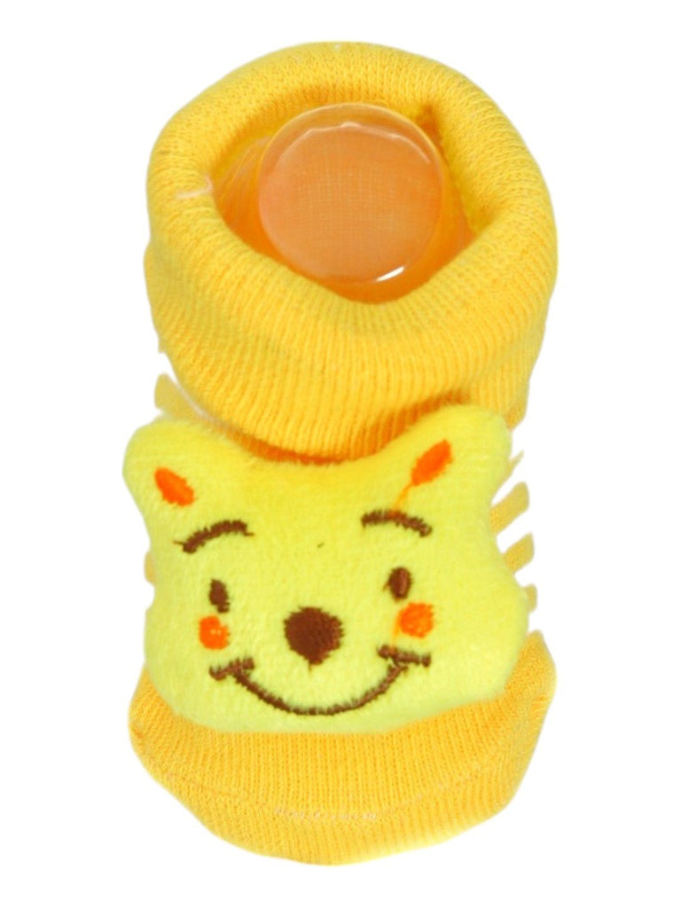 Close-up view of yellow baby booties with a 3D bear face design, perfect for infants.