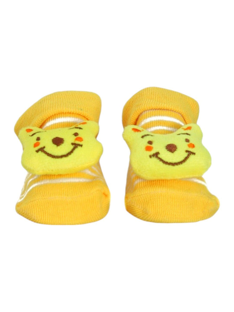 Front view of yellow baby booties with a 3D bear face, providing comfort and cuteness for babies.