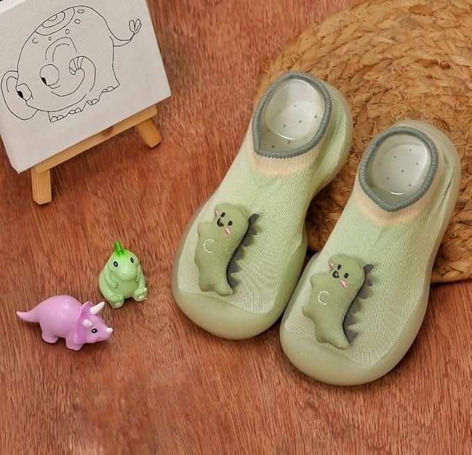 Creative view of Yellow Bee Dino Stuffed Toy Anti-Skid Rubber Sole Shoe Socks for Boys on a light background with dinosaur toys.