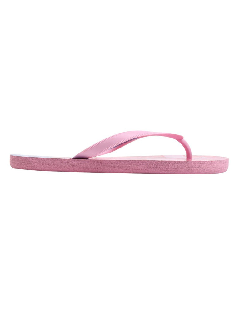 Side profile of a single girl's Peppa Pig flip-flop with a pool party print, showing the thickness of the sole and the curved shape of the comfortable strap.