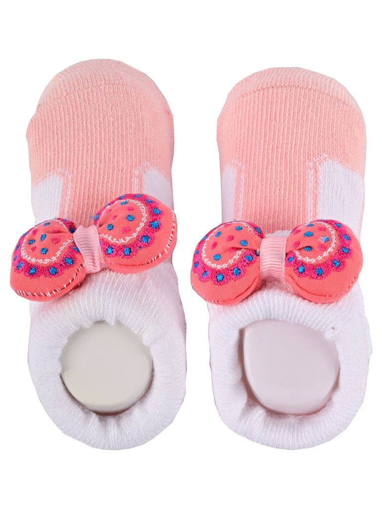 Top view of a pair of pink and white non-slip socks with bow detail and anti-slip dots
