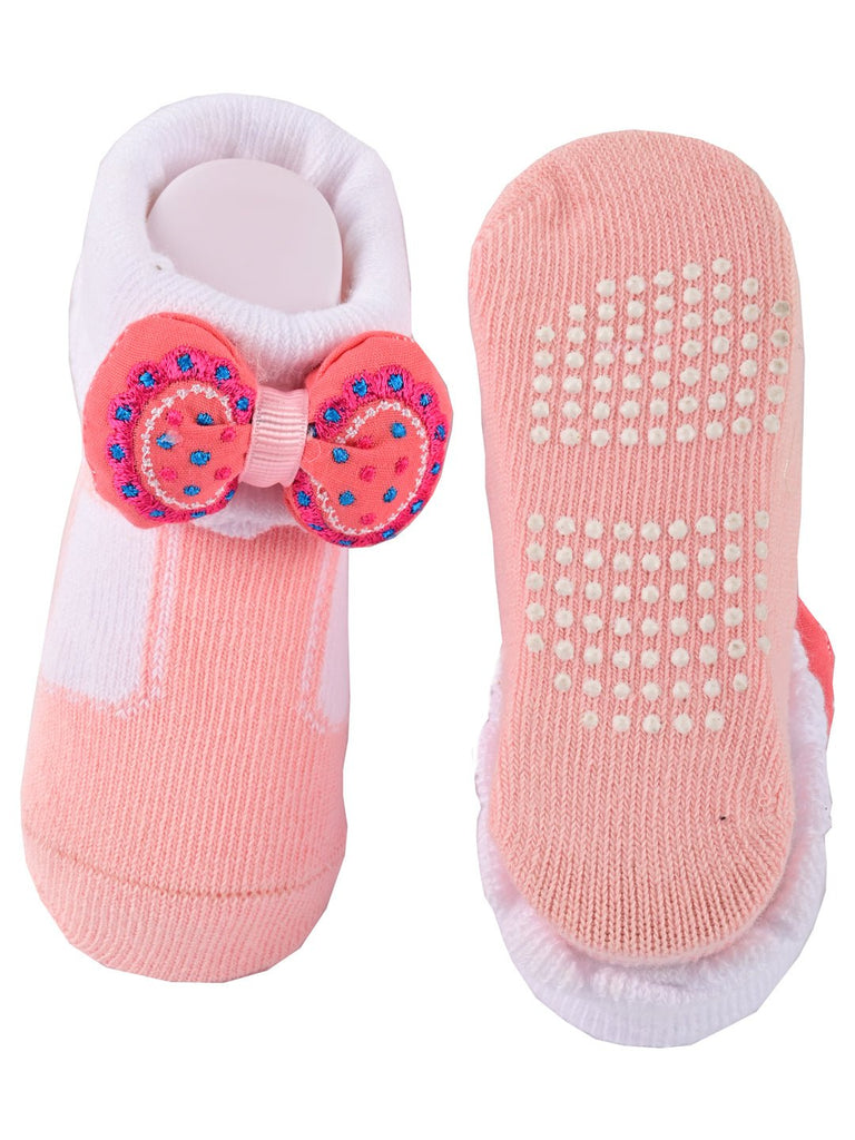 Pair of pink non-slip socks with bow embellishment and white frilly trim