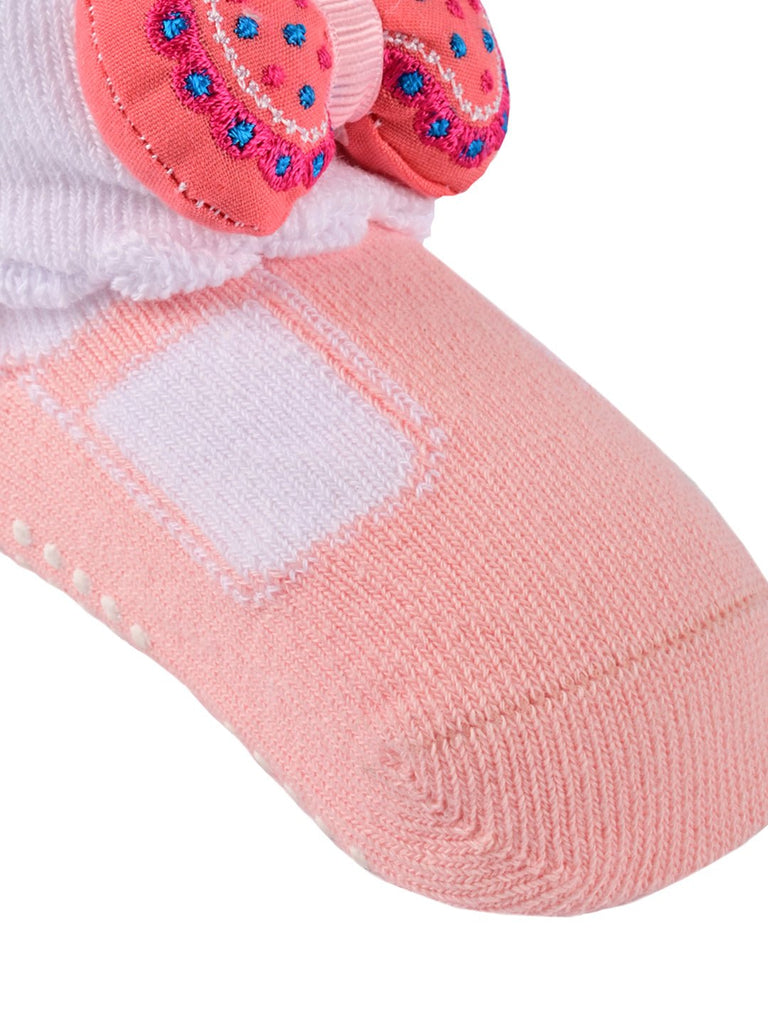 Close-up of the non-slip sole on pink bow-embellished socks