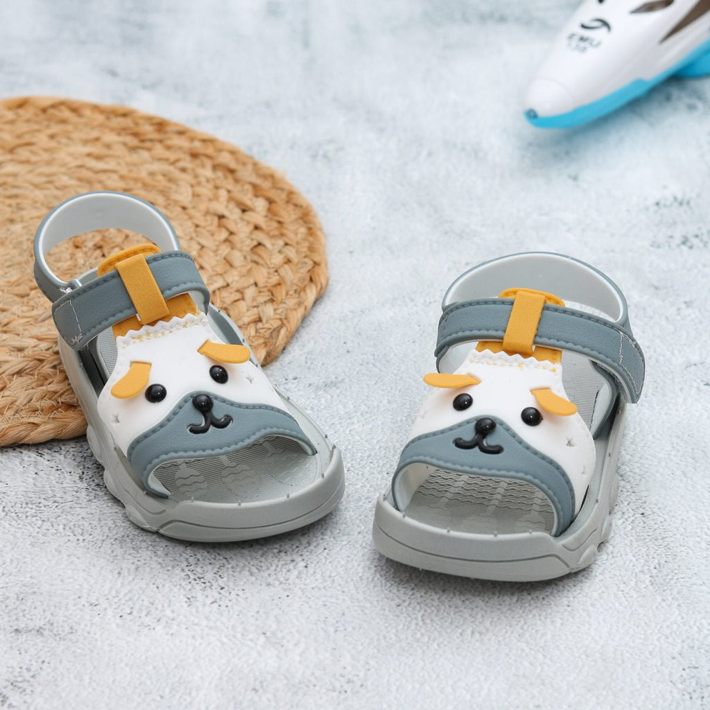 Toddler grey puppy sandals with playful design on a textured background