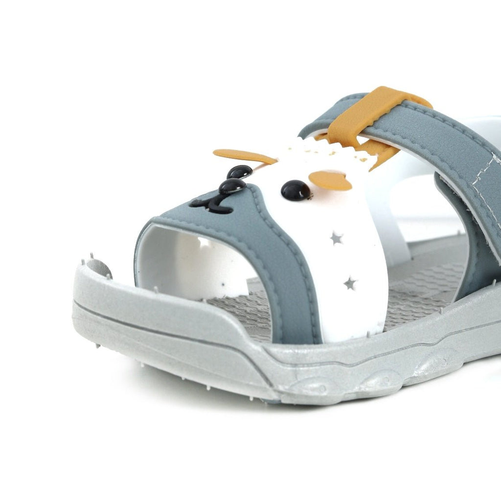 Close-up of a toddler's grey sandal with a cute puppy face design and star details