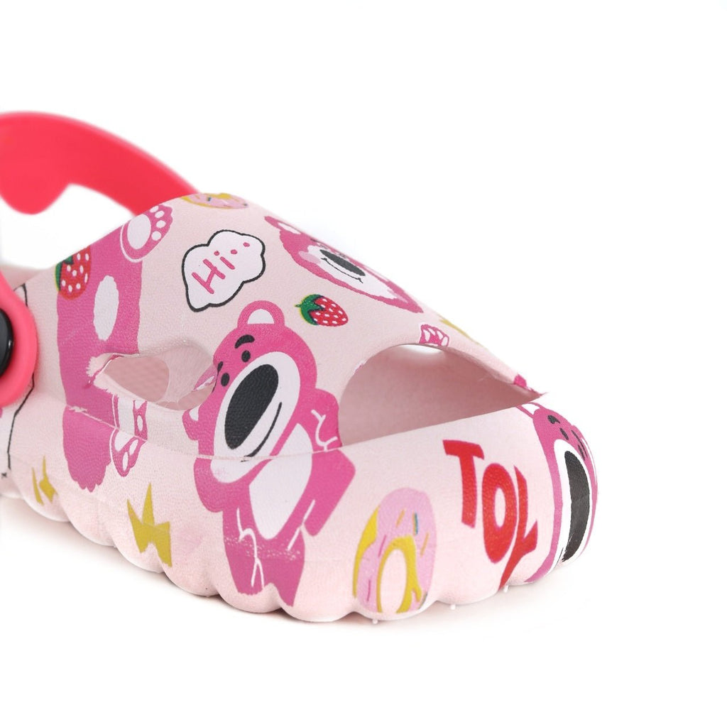 Close-up side view of the kids' pink sandals highlighting the bear and fruit prints.