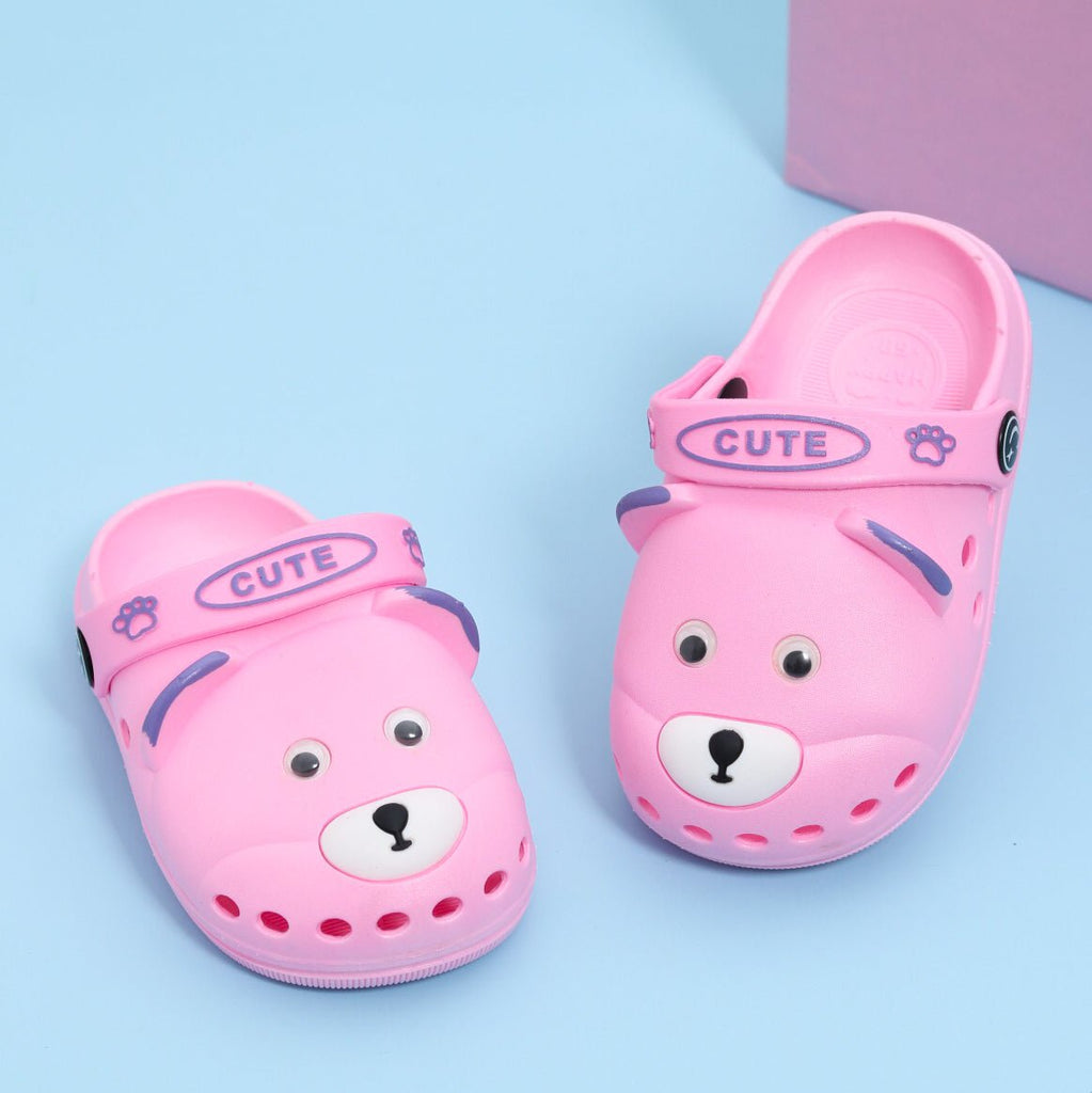 Pink clogs for kids with a cute bear design and 'CUTE' strap detail.