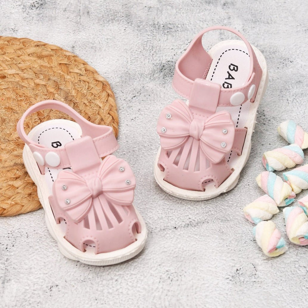 Adorable Pink Bow knot Toddler Sandals on Textured Background