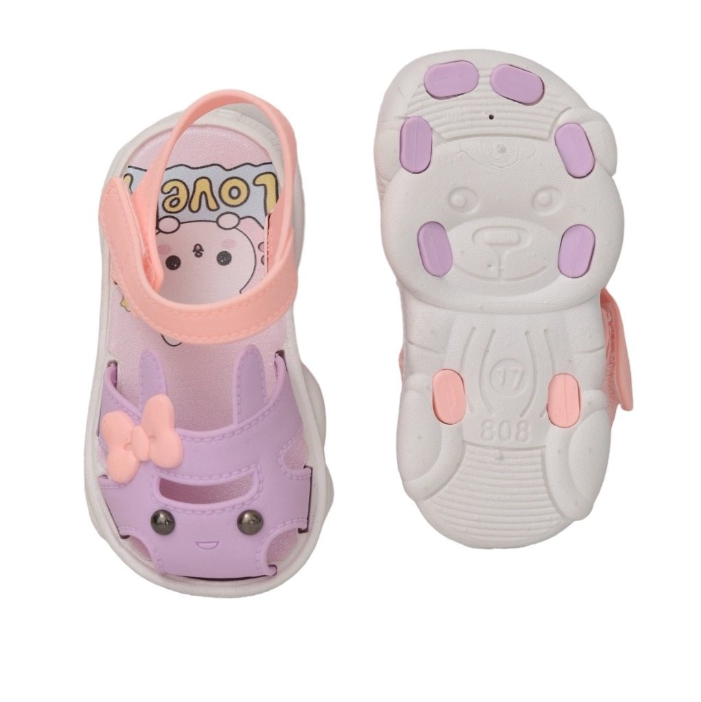 Underside of toddler sandals with a purple bunny design, highlighting the non-slip tread