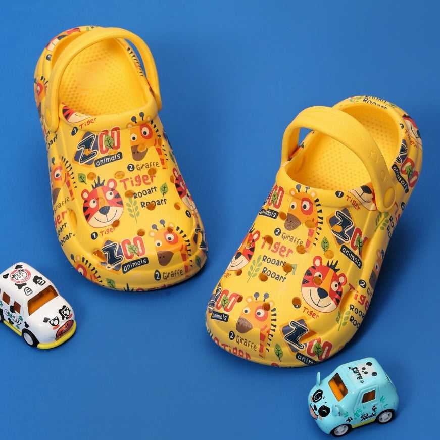 Yellow Bee boys' clogs with colorful zoo animal print on a blue background.