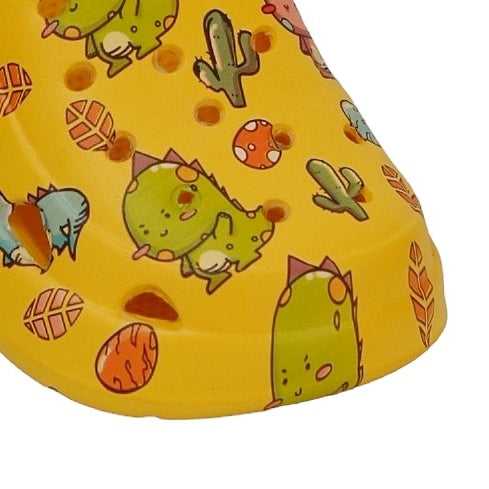 Close-up of the playful dino print on the "Jurassic Joy" Clogs by Yellow Bee.
