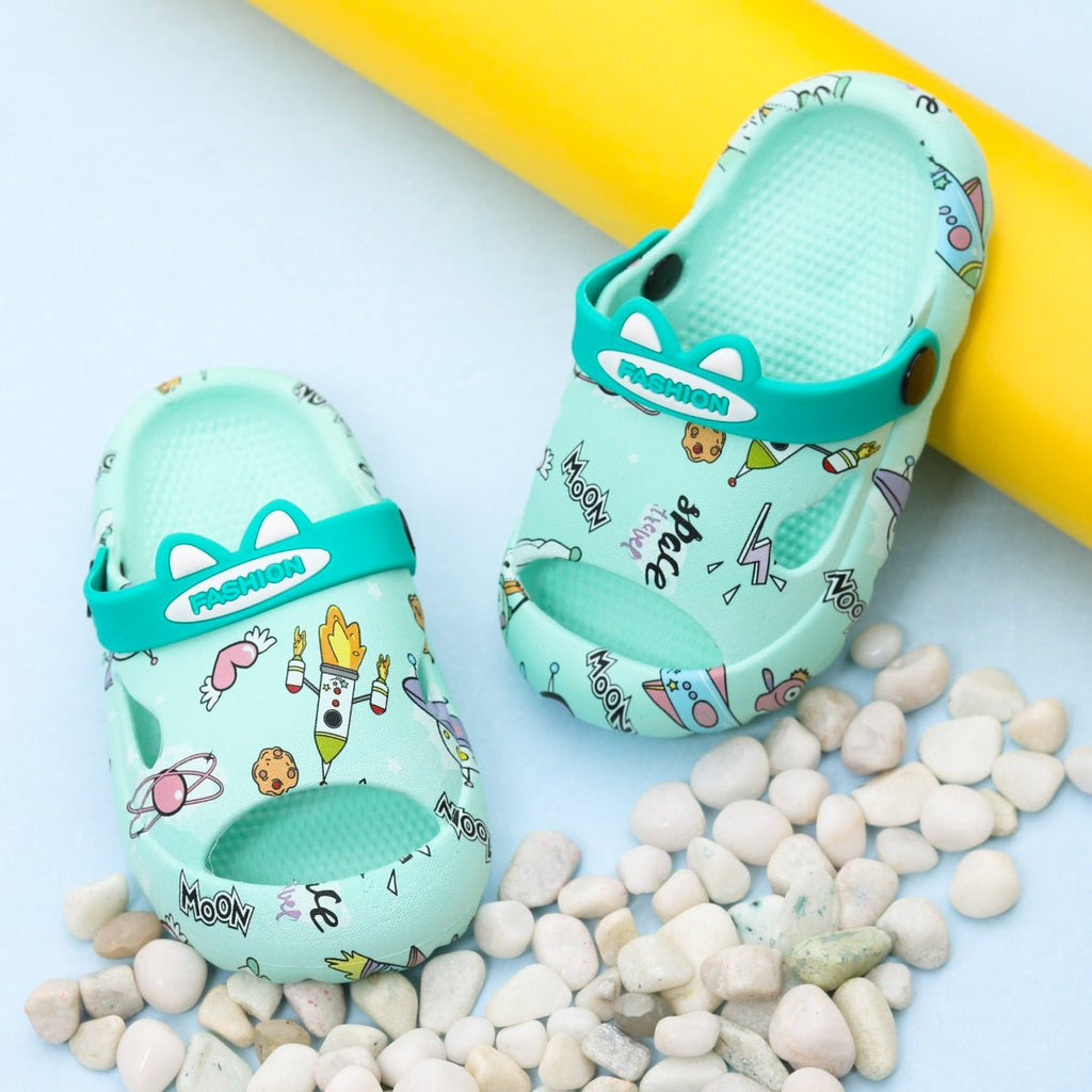 Pair of Aqua Space Theme Sandals with playful space illustrations on a sunny backdrop.