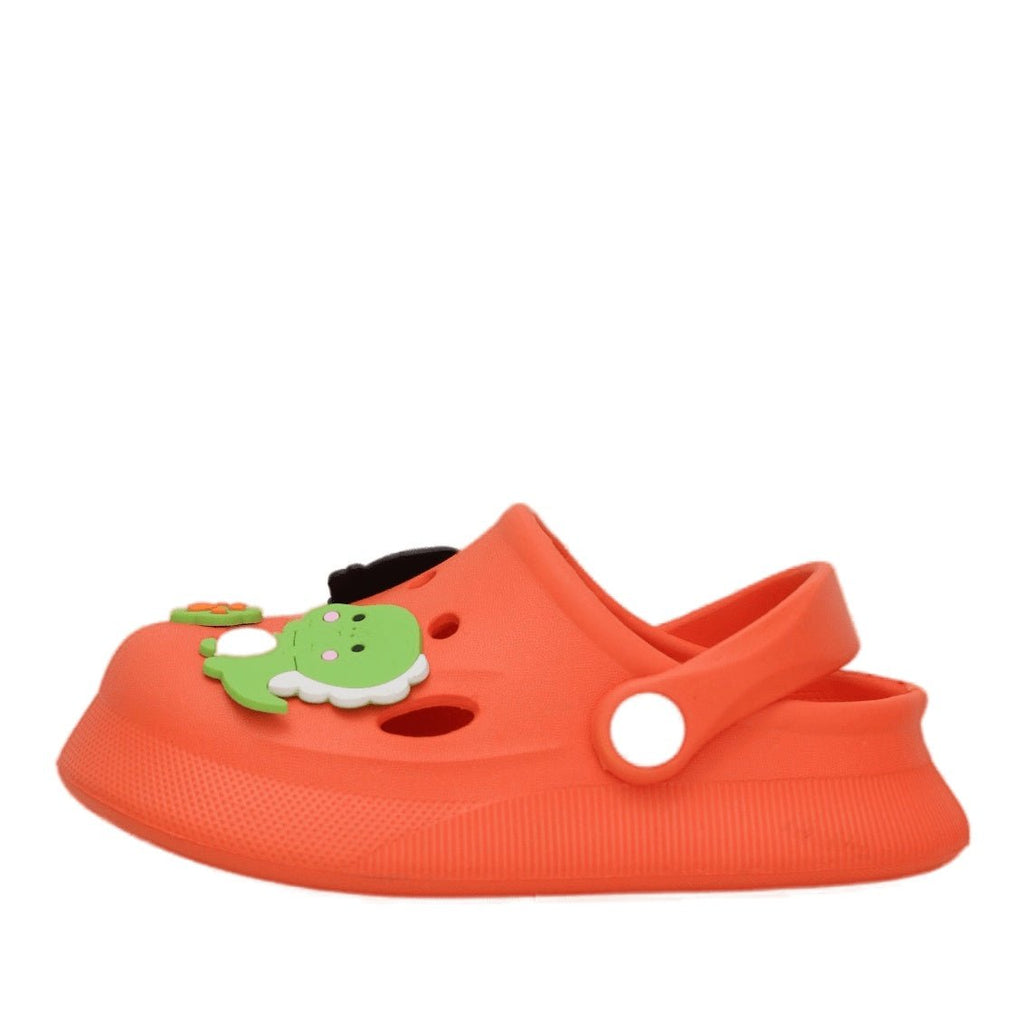 Close-up of the charming dinosaur and footprint design on boys' orange clogs.