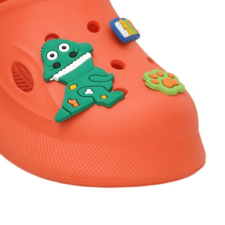 Front view of orange boys' clogs with baby dinosaur design, perfect for active little ones